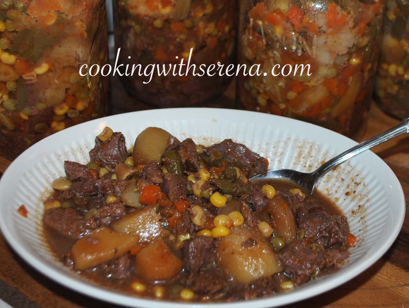 A hearty bowl of homemade canned venison stew, filled with tender chunks of venison, potatoes, carrots, corn, and green beans in a rich broth. Behind the bowl, several jars of preserved venison stew are neatly arranged, showcasing a delicious and convenient homemade meal. The text "cookingwithserena.com" is prominently displayed across the image.